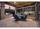 Covered outdoor patio with BBQ and ample seating, perfect for entertaining and relaxing at 41711 N Pinion Hills Ct, Anthem, AZ 85086