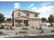 New two-story home with a two car garage, desert landscaping, and covered front porch at 4229 W Brenley Dr, San Tan Valley, AZ 85144