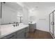Modern bathroom featuring double sinks, wood flooring and black hardware at 4238 W Brenley Dr, San Tan Valley, AZ 85144
