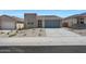 A contemporary home with desert landscaping, a two-car garage, and visible 'Available' signage at 4238 W Brenley Dr, San Tan Valley, AZ 85144