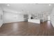 Expansive open-concept living space featuring sleek wood-look tile floors, recessed lighting, and a modern kitchen at 4238 W Brenley Dr, San Tan Valley, AZ 85144