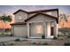 Inviting two-story home with a tile roof, attached garage, and manicured front yard, blending comfort and curb appeal at 42860 W Peters Dr, Maricopa, AZ 85138