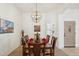 Well-lit dining room with a chandelier, decorative accents, and a view of the front door at 4936 E Villa Rita Dr, Scottsdale, AZ 85254