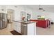 Open kitchen view featuring an island with a sink, stainless steel dishwasher, and a comfortable living area at 4936 E Villa Rita Dr, Scottsdale, AZ 85254