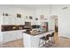 Bright kitchen with white cabinets, stainless steel appliances and a center island with barstool seating at 4936 E Villa Rita Dr, Scottsdale, AZ 85254