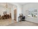 Bright office space with a large window, desk and chair, with easy access to the dining room at 4936 E Villa Rita Dr, Scottsdale, AZ 85254