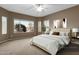 Bedroom featuring a ceiling fan, large windows, an area rug, a king bed, and an art piece at 5265 S Dante --, Mesa, AZ 85212