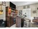 Stylish wet bar area featuring custom shelving, a built-in beverage cooler, and bar stool seating at 5334 S Parkwood --, Mesa, AZ 85212