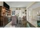 Cozy wet bar area with custom shelving, bar stool seating, and views into adjacent living spaces at 5334 S Parkwood --, Mesa, AZ 85212
