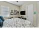 A bedroom featuring neutral walls, a queen size bed, and a flat screen television at 5334 S Parkwood --, Mesa, AZ 85212