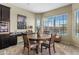 A breakfast nook showcasing a rustic round table with seating, adjacent to built-in appliances at 5334 S Parkwood --, Mesa, AZ 85212