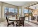A breakfast nook featuring a round wooden table and sliding glass doors to the patio and pool at 5334 S Parkwood --, Mesa, AZ 85212