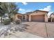 Charming single-story home featuring a three-car garage and well-manicured landscaping at 5334 S Parkwood --, Mesa, AZ 85212