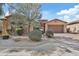 Beautiful single-story home featuring stone accents, a three-car garage, and desert landscaping at 5334 S Parkwood --, Mesa, AZ 85212