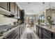 An open kitchen featuring granite counters and dark wood cabinetry looking towards an adjacent breakfast nook at 5334 S Parkwood --, Mesa, AZ 85212
