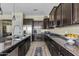 A kitchen featuring granite countertops, a stainless steel refrigerator, and dark wood cabinets at 5334 S Parkwood --, Mesa, AZ 85212