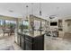 Spacious kitchen seamlessly flows into the living room, featuring pendant lights and island seating at 5334 S Parkwood --, Mesa, AZ 85212