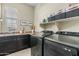 Laundry room with sink, countertop, modern machines, decor and shelving at 5334 S Parkwood --, Mesa, AZ 85212