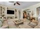 Open-concept living room showcases a built-in entertainment center, recessed lighting, and seamless flow to other spaces at 5334 S Parkwood --, Mesa, AZ 85212