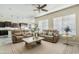 Bright living room featuring comfortable seating, ceiling fan, and views into the adjacent kitchen at 5334 S Parkwood --, Mesa, AZ 85212