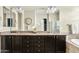 Main bathroom with double sinks, large mirror, granite countertops and separate tub and shower at 5334 S Parkwood --, Mesa, AZ 85212