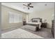 Spacious main bedroom features a large window, bench seating, and a ceiling fan at 5334 S Parkwood --, Mesa, AZ 85212