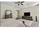 Comfortable main bedroom features a ceiling fan, carpet, and an entertainment center at 5334 S Parkwood --, Mesa, AZ 85212