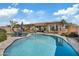Sparkling pool with lounge chairs and umbrellas, complemented by lush landscaping and home exterior at 5334 S Parkwood --, Mesa, AZ 85212