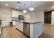 Spacious kitchen featuring a center island with a stainless steel dishwasher and a decorative barn door at 559 W Magena Dr, San Tan Valley, AZ 85140