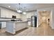 Bright, white kitchen featuring stainless steel appliances, a center island, and wood-look tile flooring at 559 W Magena Dr, San Tan Valley, AZ 85140