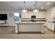 Open-concept space showcasing the kitchen with a center island and a living area with a mounted television at 559 W Magena Dr, San Tan Valley, AZ 85140