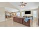 Open-concept living room featuring tile floors and an archway into the kitchen and dining area at 5653 E Athena Rd, Florence, AZ 85132