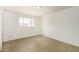 Bright bedroom with tile floors and a window offers a clean and simple aesthetic at 5730 N 61St Ln, Glendale, AZ 85301