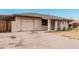 Inviting single-story home with a front-facing garage, mature shrubbery, and a lush, green lawn and driveway at 5730 N 61St Ln, Glendale, AZ 85301