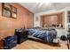 Cozy bedroom featuring hardwood floors, a ceiling fan, and a large window at 6217 W Orange Dr, Glendale, AZ 85301