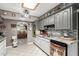 Well-lit kitchen with gray cabinetry, modern appliances, and chef decor throughout at 6217 W Orange Dr, Glendale, AZ 85301