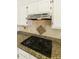 Close-up of kitchen with granite countertops, tile backsplash, stainless vent, and a sleek gas cooktop at 6791 W Megan St, Chandler, AZ 85226