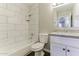 Bathroom featuring stylish white tiling, granite counters, and modern fixtures at 707 N 92Nd Pl, Mesa, AZ 85207