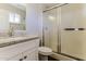 Bright bathroom featuring a granite countertop vanity and glass-enclosed shower at 707 N 92Nd Pl, Mesa, AZ 85207