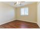 Bedroom with wood flooring, bright window, and ceiling fan at 707 N 92Nd Pl, Mesa, AZ 85207