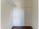 Walk in closet with hardwood floors and white walls at 707 N 92Nd Pl, Mesa, AZ 85207