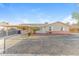 Charming single-story home featuring a tidy front yard with desert landscaping and a covered carport at 707 N 92Nd Pl, Mesa, AZ 85207