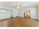 Bright living room boasts wood floors, fresh paint, and a ceiling fan for added comfort at 707 N 92Nd Pl, Mesa, AZ 85207