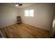 Neutral bedroom featuring hardwood floors, a ceiling fan, and a chair by the window at 7420 W Cinnabar Ave, Peoria, AZ 85345