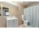 Bright bathroom featuring a vanity with a mirror and patterned shower curtain at 7808 W Palo Verde Dr, Glendale, AZ 85303