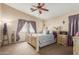 This bedroom is spacious with neutral walls, carpeted floors, and a ceiling fan at 7808 W Palo Verde Dr, Glendale, AZ 85303
