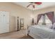 Bright bedroom showcasing carpet floors, neutral walls, ceiling fan and large window at 7808 W Palo Verde Dr, Glendale, AZ 85303