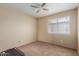 This bedroom features neutral walls, carpet, and a window for natural light at 7808 W Palo Verde Dr, Glendale, AZ 85303