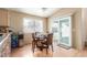 Cozy dining area features a wood table, four chairs, and a sliding glass door to the backyard at 7808 W Palo Verde Dr, Glendale, AZ 85303