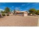 Exterior view of home with desert landscaping and attached garage at 7808 W Palo Verde Dr, Glendale, AZ 85303